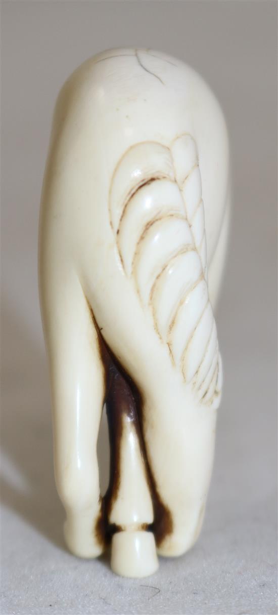 A Japanese stag antler netsuke of a horse, 18th/19th century, 4.9cm